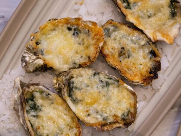 What Gives Oysters Rockefeller Their Signature Green Hue and Rich Flavor?